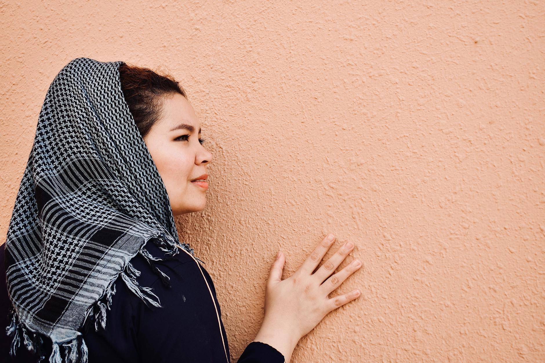 woman leaning on wall